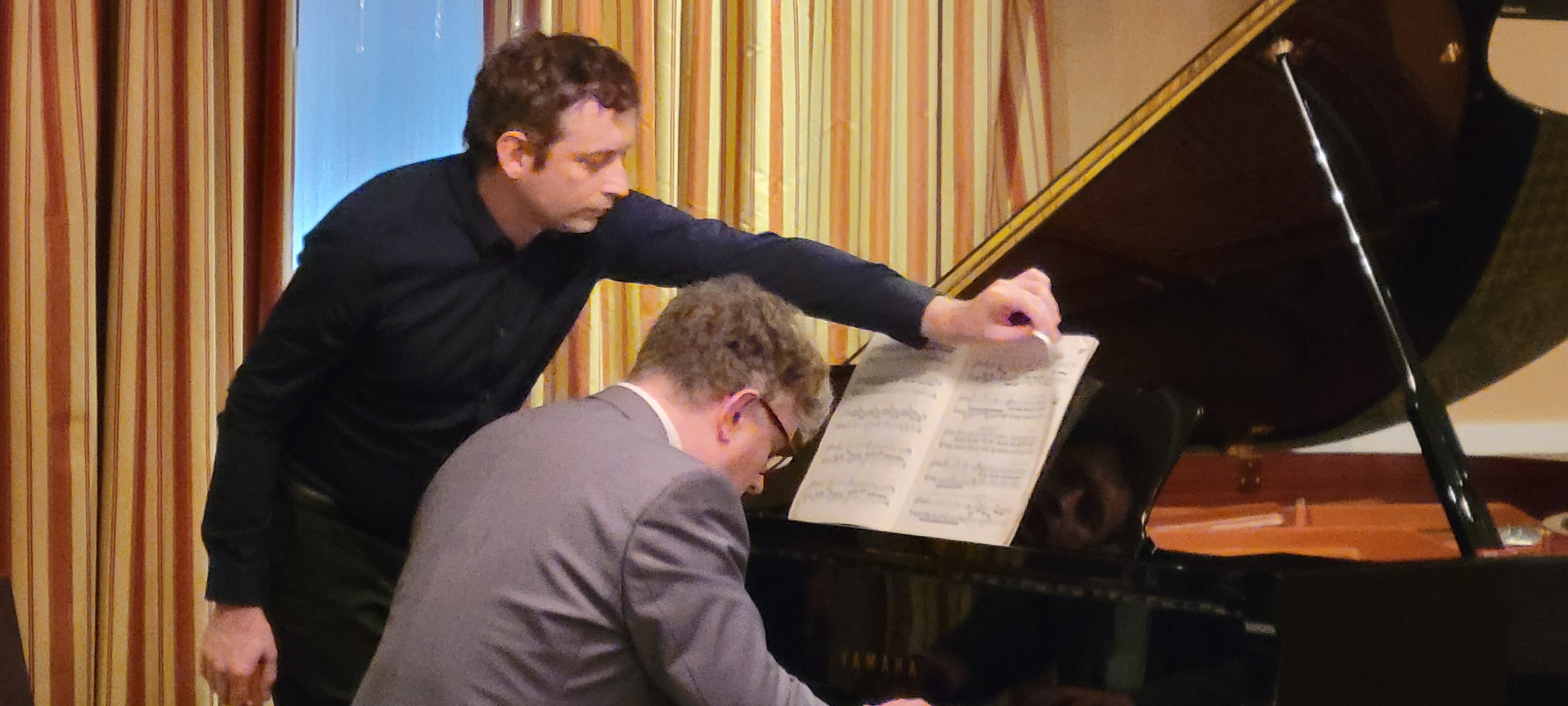 A page turner assisting a pianist during a WIPAC competition round